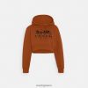 Coach γυναίκες cropped hoodie με άλογο και άμαξα από οργανικό βαμβάκι καστανός LBZ422480 Coach Παπουτσια